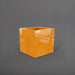 Montroy Cube Fiberglass Planter in gloss tangerine against gray background.