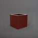 Montroy Cube Fiberglass Planter in matte terra cotta against gray background.