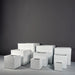 Montroy Cube Fiberglass Planter on concrete shown with different sizes.