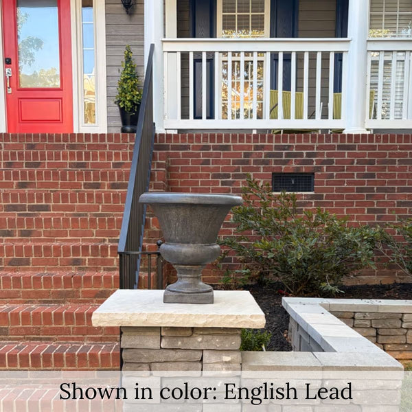 Mt. Airy Urn planter displayed on a stone pillar beside red brick steps at a front porch.