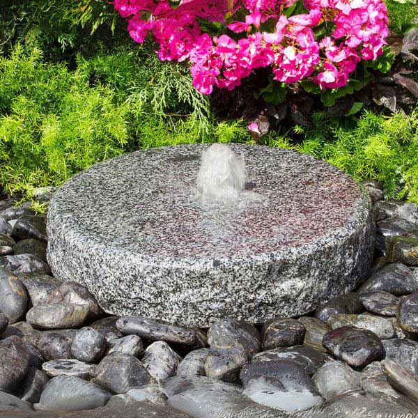 Natural Round Fountain on black peebles in action