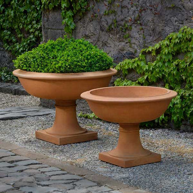 Notting Hill Urn Planter on gravel filled with plants