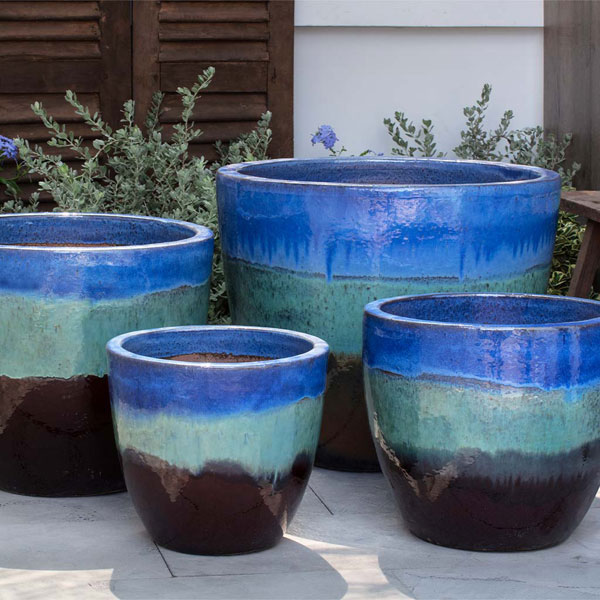 Ocho Planter - Running Blue/Brown - S/4 on concrete in the backyard