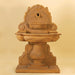 Olive Grove Wall Fountain against brown background.