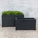 Oxford Rectangle Planter, Small - Onyx Black Lite on gravel filled with plants