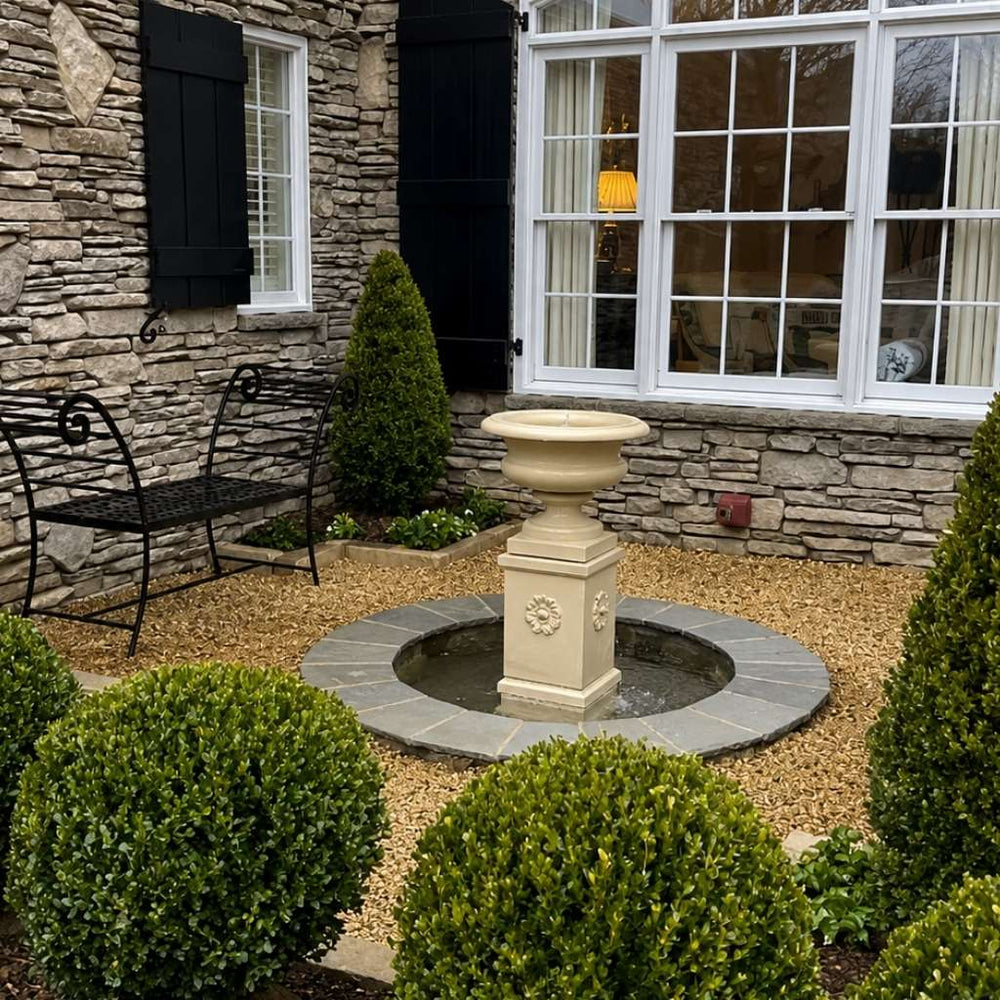 Palazzo Urn Fountain beside window surrounded with plants