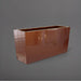 Panama Tapered Rectangle Planter in metallic bronze against gray background.