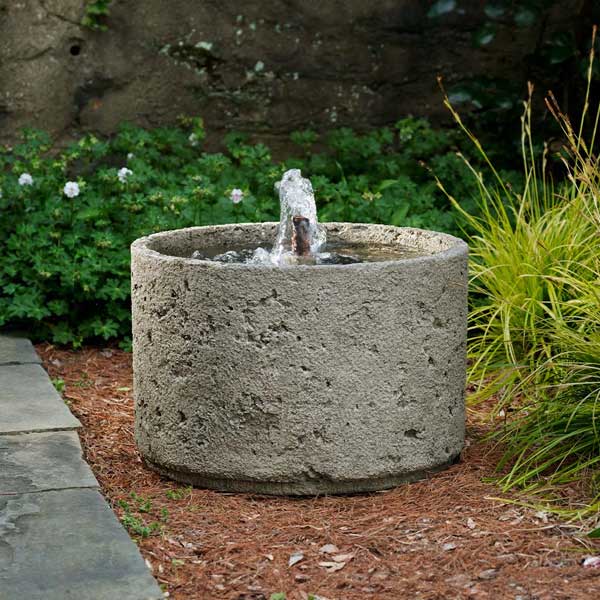 Paros Fountain on the ground with plants background