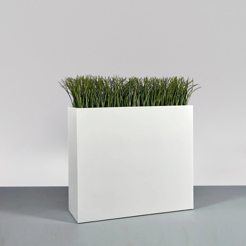 Perth Tall Rectangle Fiberglass Planter on concrete filled with plants.