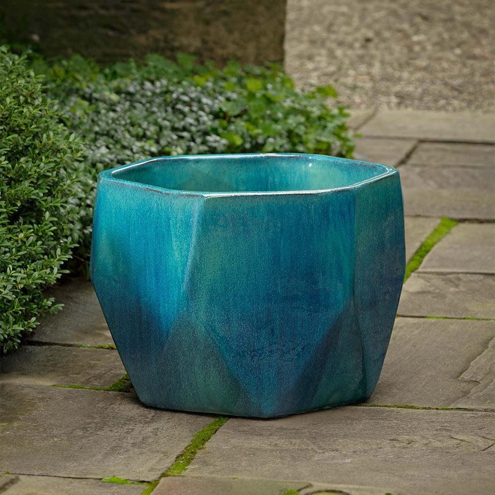 Prism Planter - Aqua on concrete in the backyard.