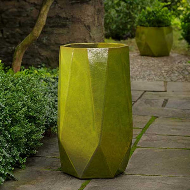 Prism Planter, Tall - Emerald on concrete in the backyard