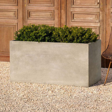 Rectangle Planter 48x24x24 on gravel filled with plants.