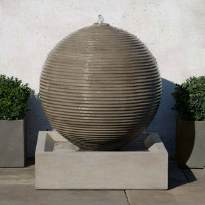 Ribbed Sphere Fountain on concrete in the backyard