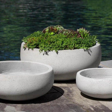 Rio Bowl Planter  in Playa Noche filled with plants beside swimming pool