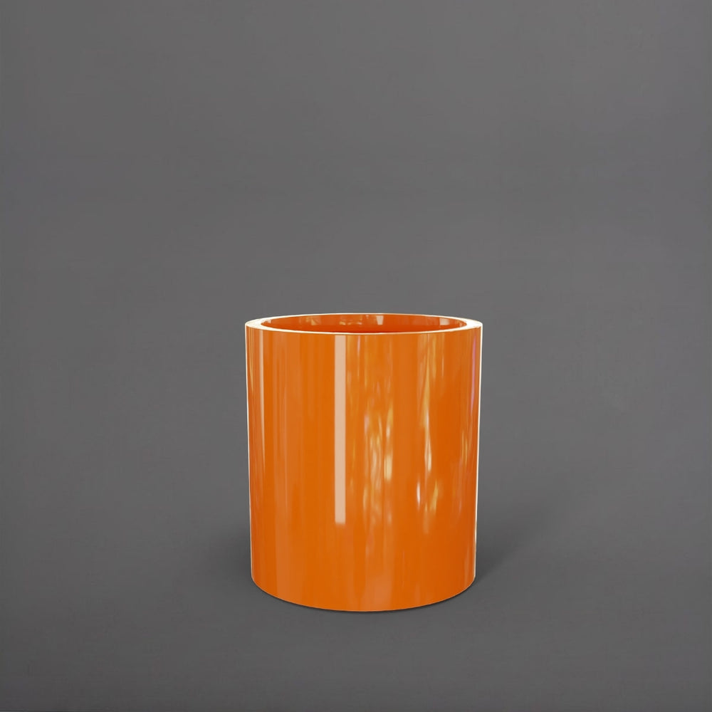 Rio Grande Cylinder Fiberglass Planter in gloss tangerine against gray background.