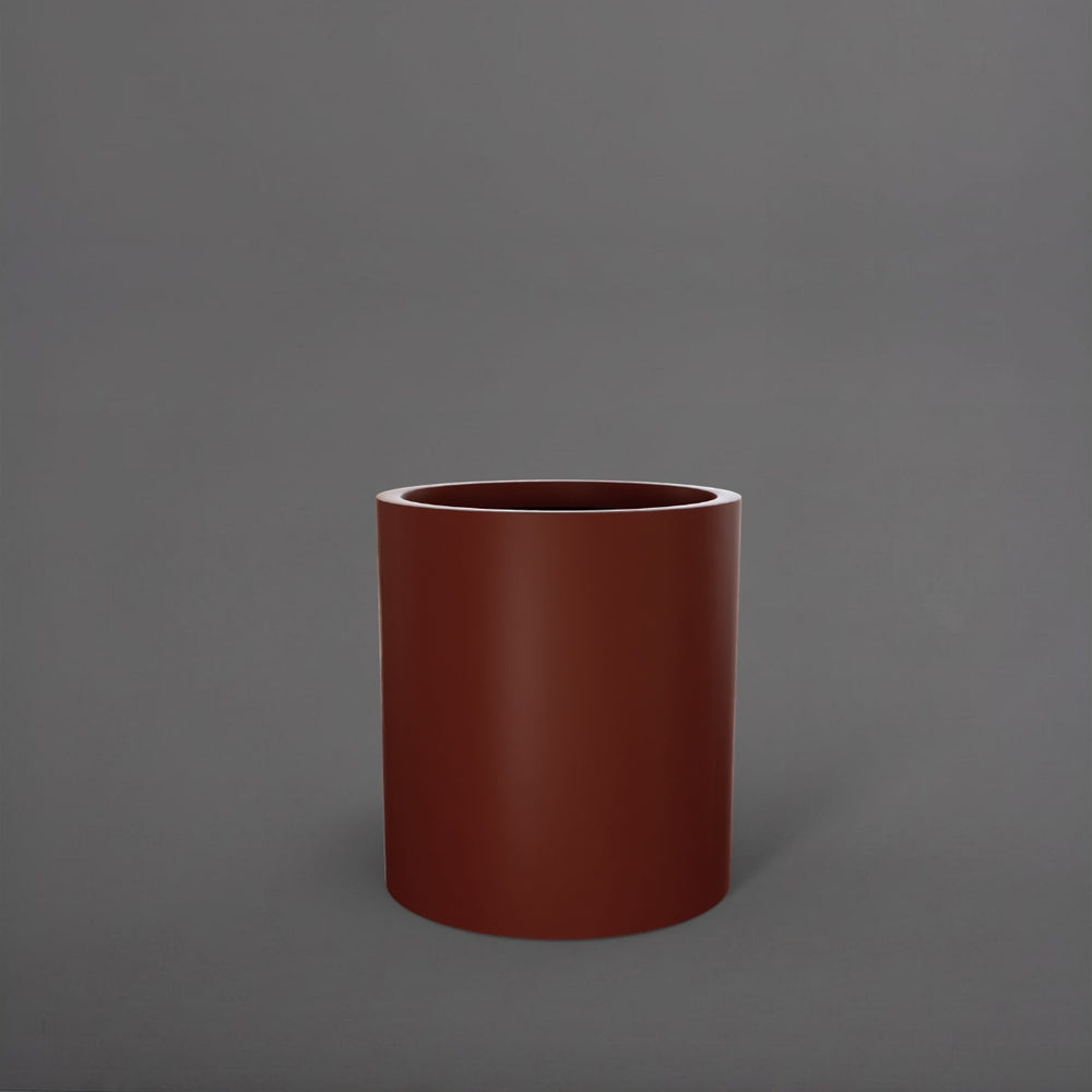 Rio Grande Cylinder Fiberglass Planter in matte terra cotta against gray background.