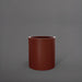 Rio Grande Cylinder Fiberglass Planter in matte terra cotta against gray background.