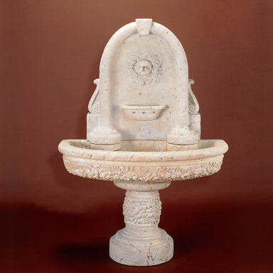 Robbiana Wall Fountain against brown background.