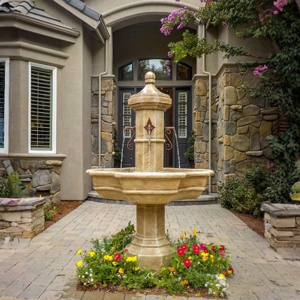 Roubaix Fountain for Rustic Spouts on ground surrounded with flowers.