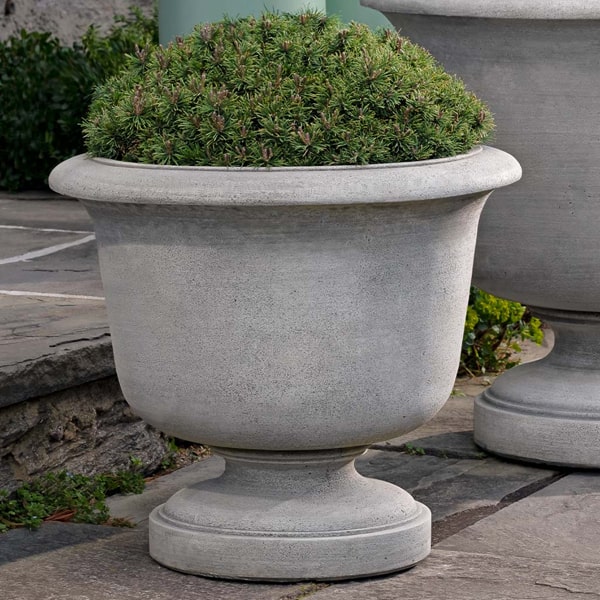 Sag Harbor Urn Planter on concrete filled with plants