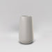 Saigon Tapered Round Fiberglass Planter in matte cement grey against gray background.