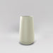 Saigon Tapered Round Fiberglass Planter in satin beige against gray background.