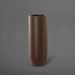 Saint Tropez Tall Bullet Round Fiberglass Planter in matte dark brown against gray background.