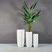 Saint Tropez Tall Bullet Round Fiberglass Planter shown with different sizes filled with plants.