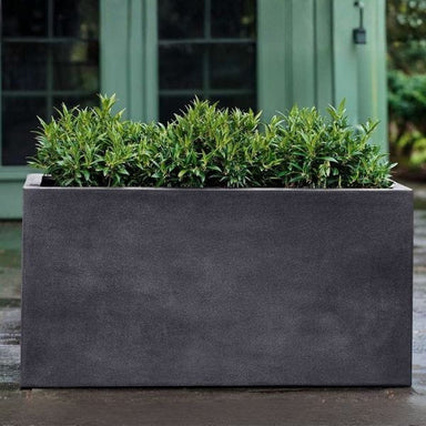 Sandal Planter 482424 S/1 in charcoal premium lite on concrete filled with plants.