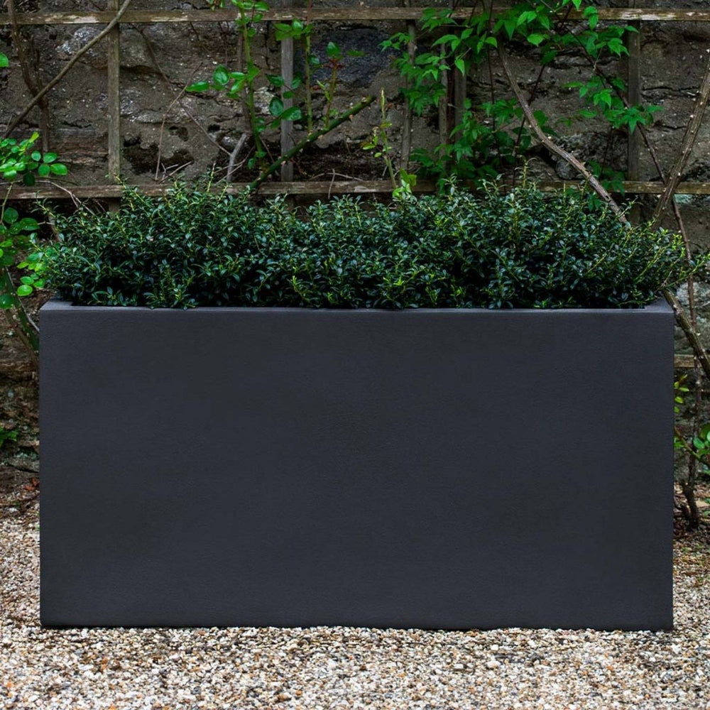 Sandal Planter 482424 S/1 in lead lite on gravel filled with plants.