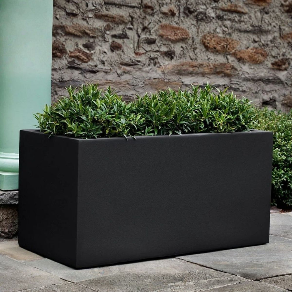 Sandal Planter 482424 S/1 in onyx black lite on concrete filled with plants.