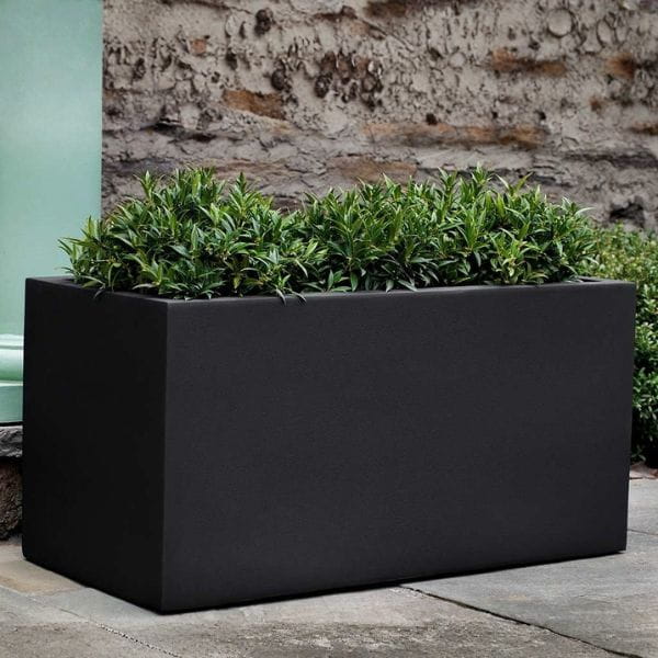 Sandal Planter 482424 S/1 in onyx black lite on concrete filled with plants.