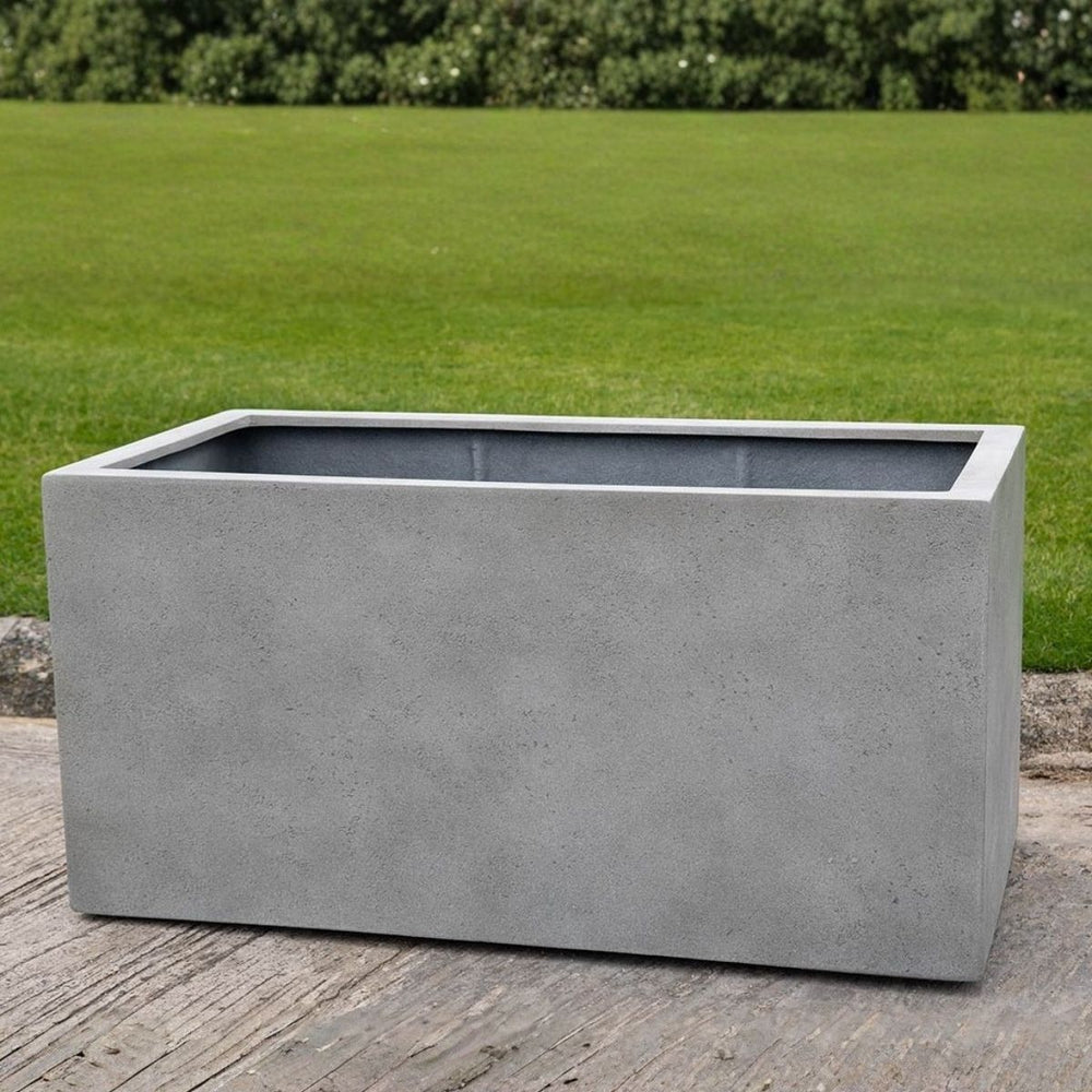 Sandal Planter 482424 S/1 in stone grey lite on concrete in the backyard.