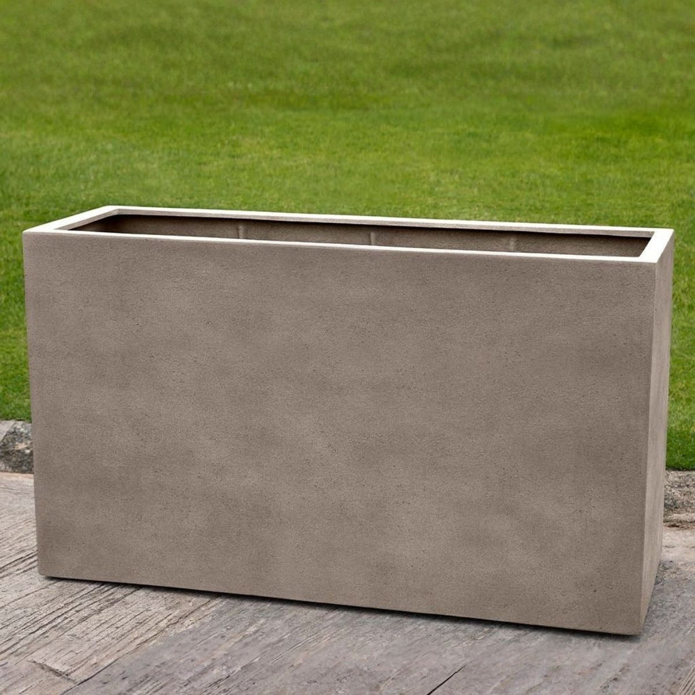 Sandal Planter 591836 S/1 in riverstone premium lite on concrete in the backyard.