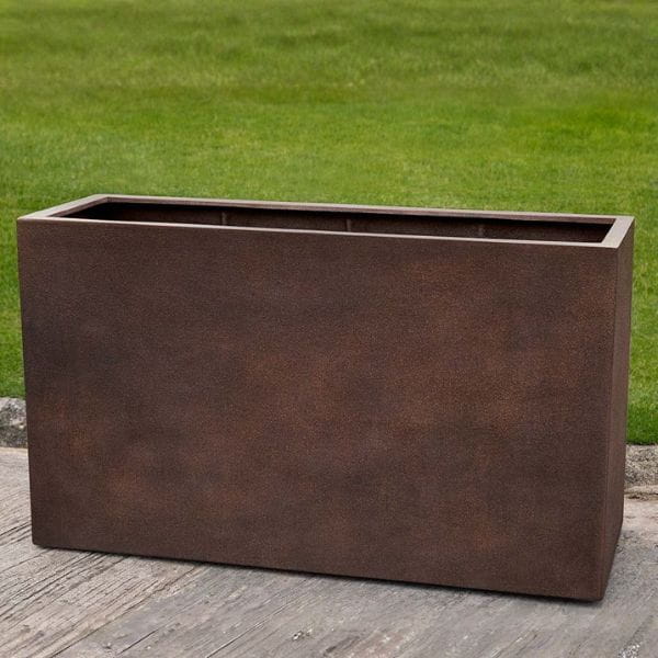 Sandal Planter 591836 S/1 in rust lite on concrete in the backyard.
