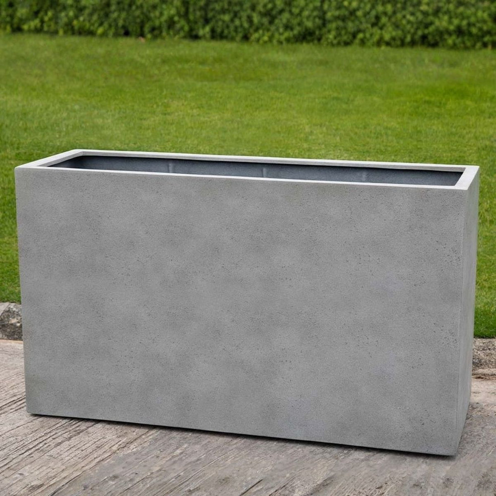 Sandal Planter 591836 S/1 in stone grey lite on concrete in the backyard.