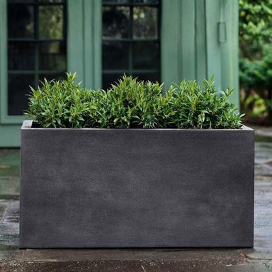 Sandal Planter 592424 S/1 in charcoal premium lite on concrete filled with plants.