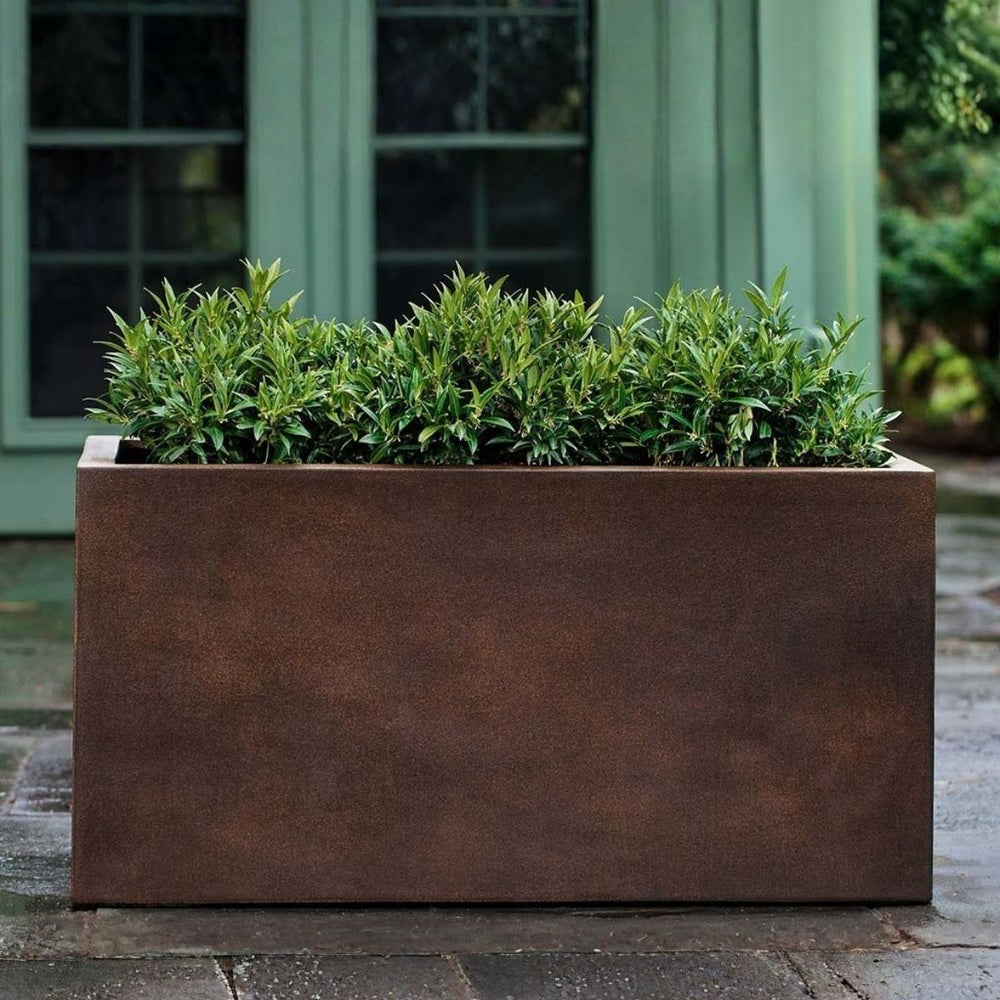 Sandal Planter 592424 S/1 in rust lite on concrete filled with plants.