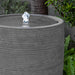 Sedona Bubbling Water feature in stone ledge in action near plants upclose.