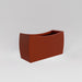 Seoul Modern Curved Rectangle Fiberglass Planter in matte terra cotta against gray background.