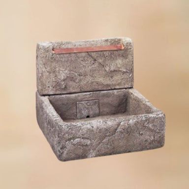 Shallow Cistern Fountain  with Copper Overflow against brown background.