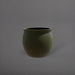 Shanghai Fishbowl Fiberglass Planter in matte bronze against gray background.