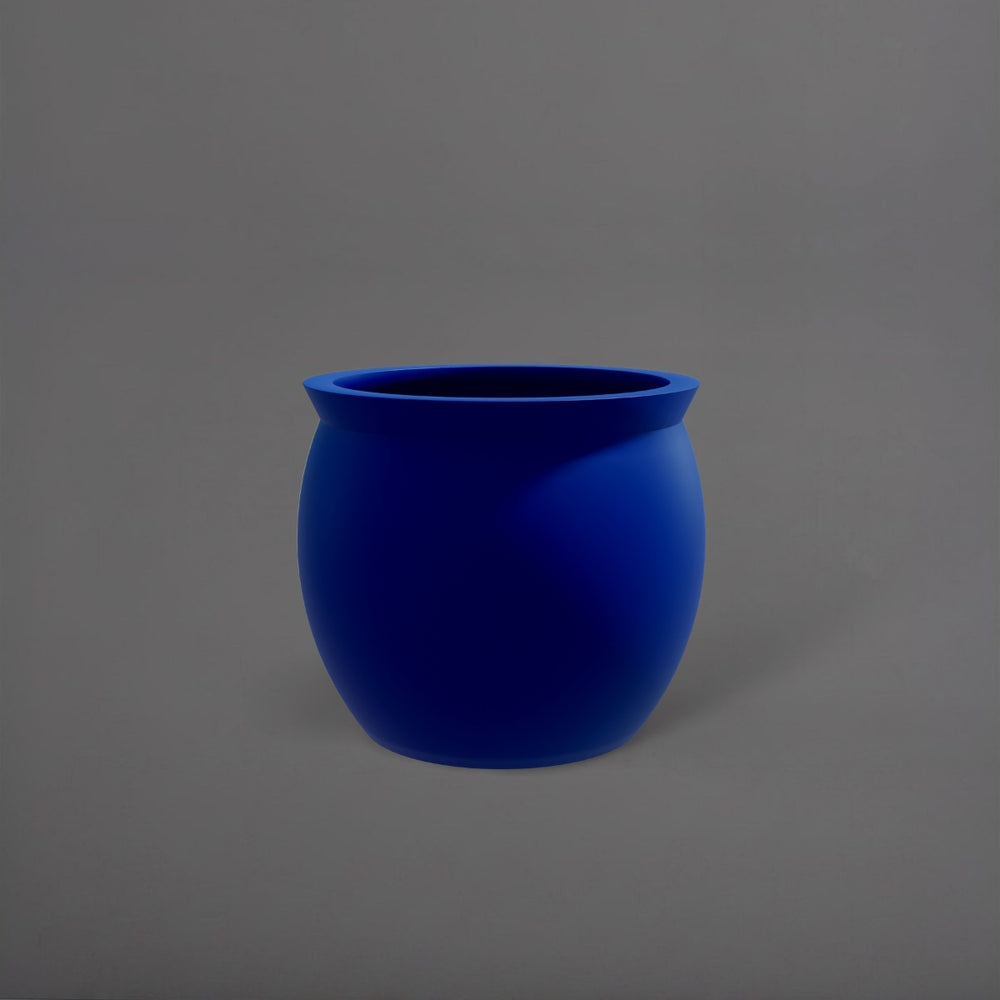 Shanghai Fishbowl Fiberglass Planter in matte cobalt blue against gray background.