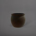 Shanghai Fishbowl Fiberglass Planter in matte dark brown against gray background.