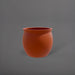 Shanghai Fishbowl Fiberglass Planter in matte terra cotta against gray background.