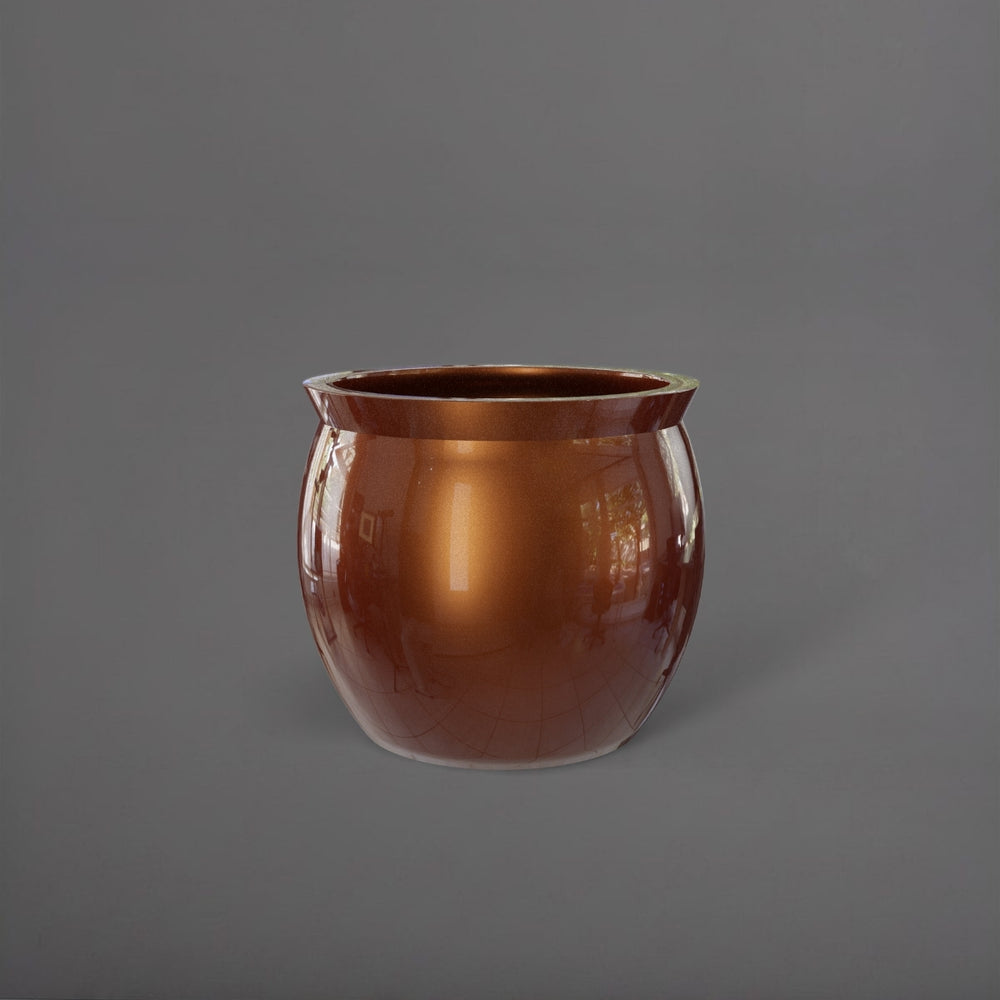 Shanghai Fishbowl Fiberglass Planter in metallic bronze against gray background.