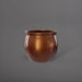 Shanghai Fishbowl Fiberglass Planter in metallic bronze against gray background.