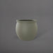 Shanghai Fishbowl Fiberglass Planter in satin beige against gray background.