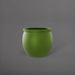 Shanghai Fishbowl Fiberglass Planter in satin green against gray background.