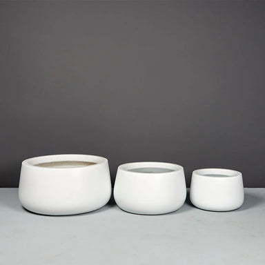 Short Hayden Tapered Round Fiberglass Planter in 3 different sizes on concrete 